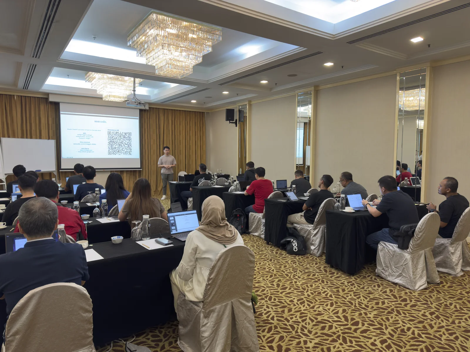 A Sozcode trainer teaching a class of participants working on laptops